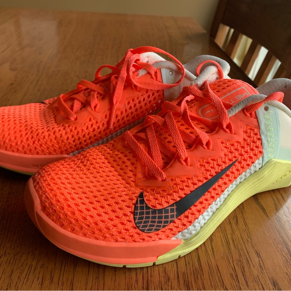 Nike running cross fit shoes. Bright mango color. Great condition. Size 7.